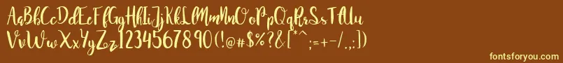 JuanitaBrushSmooth-fontti – keltaiset fontit ruskealla taustalla