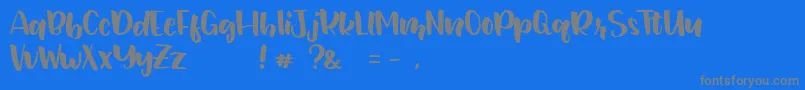 JunetteDEMO Regular-fontti – harmaat kirjasimet sinisellä taustalla
