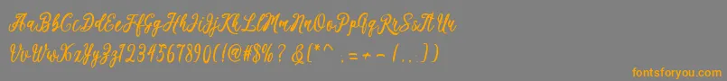 フォントKaeshum – オレンジの文字は灰色の背景にあります。