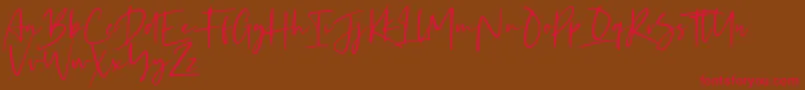 フォントKaileigh – 赤い文字が茶色の背景にあります。