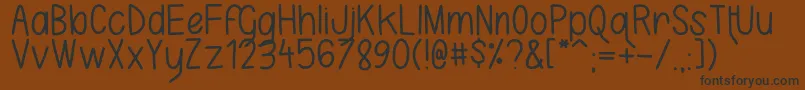 KarlaCamilla-fontti – mustat fontit ruskealla taustalla
