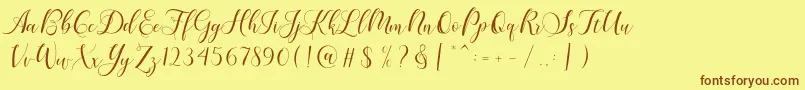 フォントKarliyna Script – 茶色の文字が黄色の背景にあります。