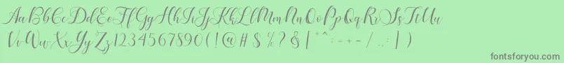 Fonte Karliyna Script – fontes cinzas em um fundo verde