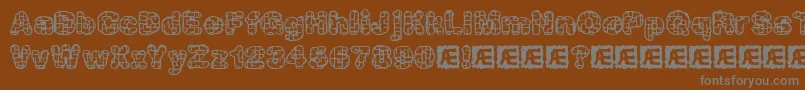 kataacti-fontti – harmaat kirjasimet ruskealla taustalla