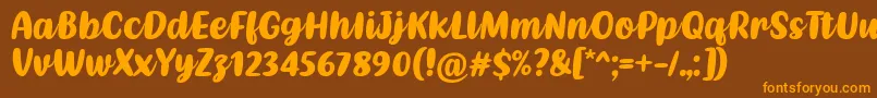 フォントKathen Font by Situjuh 7NTypes – オレンジ色の文字が茶色の背景にあります。