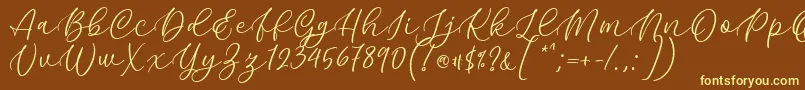 Kelidya Font by Keithzo 7NTypes-fontti – keltaiset fontit ruskealla taustalla