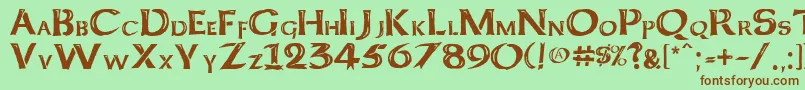 Fonte Kelt Caps Freehand – fontes marrons em um fundo verde