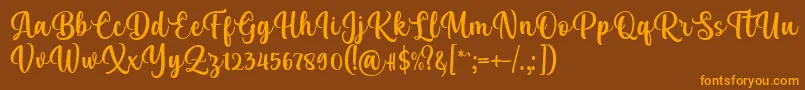 Kelya Font by 7NTypes-Schriftart – Orangefarbene Schriften auf braunem Hintergrund