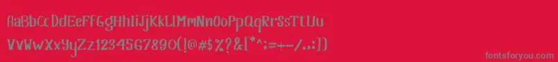 フォントKhasanah Brush – 赤い背景に灰色の文字