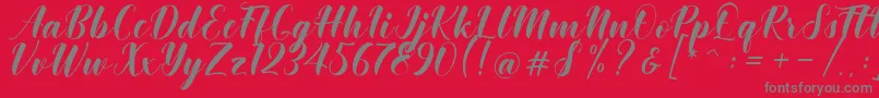 Fonte Khinta Script – fontes cinzas em um fundo vermelho