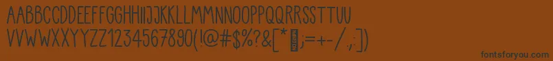 Kiddo Handwriting-Schriftart – Schwarze Schriften auf braunem Hintergrund