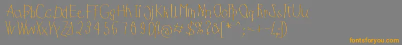 フォントKidsFirstPrintFont – オレンジの文字は灰色の背景にあります。