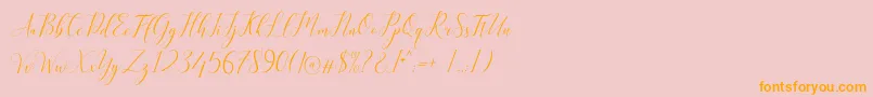 フォントKimberly – オレンジの文字がピンクの背景にあります。