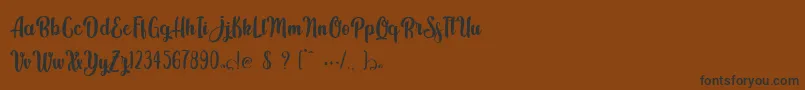 Шрифт Kindly Jasmine – чёрные шрифты на коричневом фоне