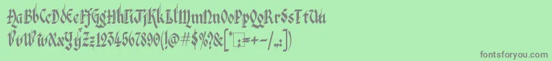 フォントKingthings Italique – 緑の背景に灰色の文字