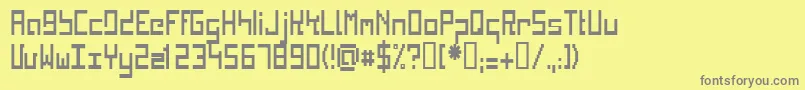 KINKC   -fontti – harmaat kirjasimet keltaisella taustalla