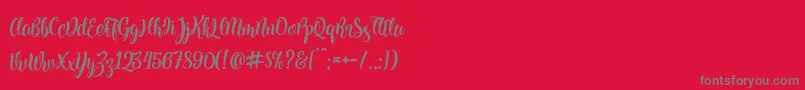 Kite Script-Schriftart – Graue Schriften auf rotem Hintergrund