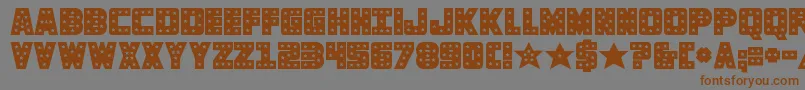 フォントknievelsolid – 茶色の文字が灰色の背景にあります。