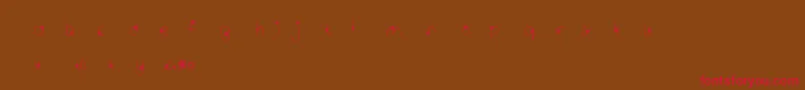 フォントMtfWildflower – 赤い文字が茶色の背景にあります。