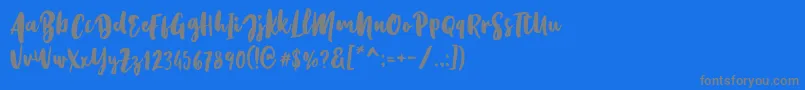 Kristale Script Font – Gray Fonts on Blue Background