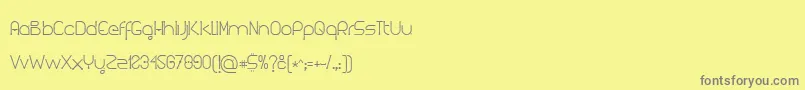 フォントKuasar – 黄色の背景に灰色の文字