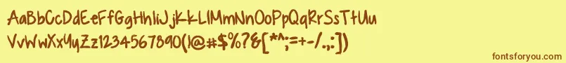 フォントKUASQUE – 茶色の文字が黄色の背景にあります。