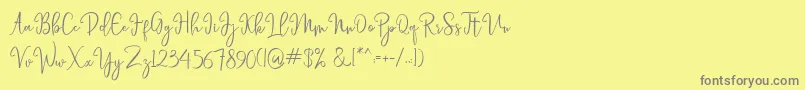 フォントlaneisha – 黄色の背景に灰色の文字