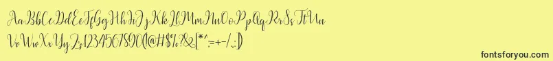 Fonte Latasha Script – fontes pretas em um fundo amarelo