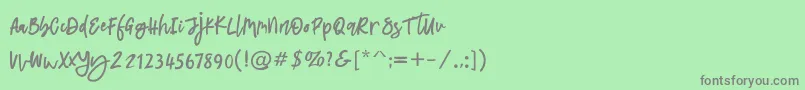 フォントLatifah – 緑の背景に灰色の文字