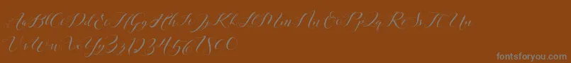 Laurence Script DEMO-Schriftart – Graue Schriften auf braunem Hintergrund