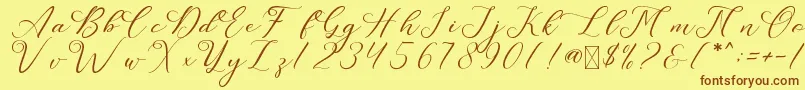 フォントLeslieDawn – 茶色の文字が黄色の背景にあります。