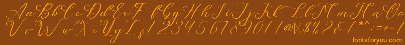 フォントLeslieDawn – オレンジ色の文字が茶色の背景にあります。