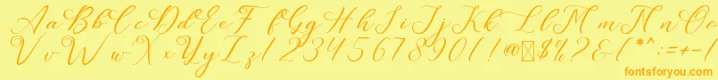 フォントLeslieDawn – オレンジの文字が黄色の背景にあります。
