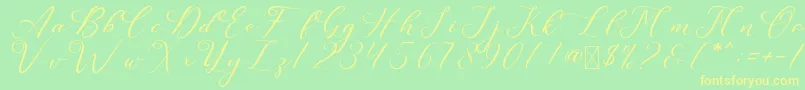 フォントLeslieDawn – 黄色の文字が緑の背景にあります
