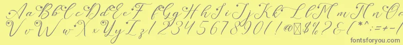 LeslieDawnLove-fontti – harmaat kirjasimet keltaisella taustalla