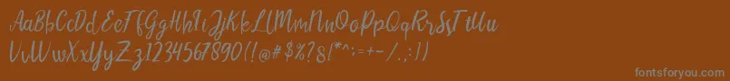 フォントLIONELLOSCRIPTRegular – 茶色の背景に灰色の文字