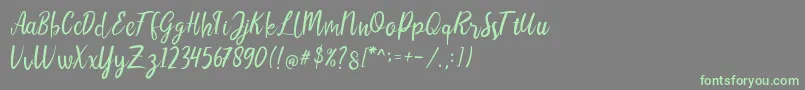 LIONELLOSCRIPTRegular Font – Green Fonts on Gray Background