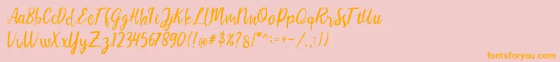 フォントLIONELLOSCRIPTRegular – オレンジの文字がピンクの背景にあります。