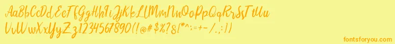 フォントLIONELLOSCRIPTRegular – オレンジの文字が黄色の背景にあります。