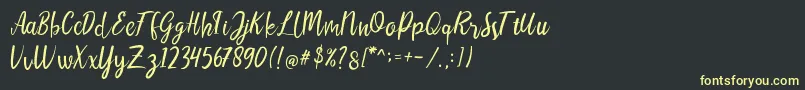 LIONELLOSCRIPTRegular Font – Yellow Fonts on Black Background