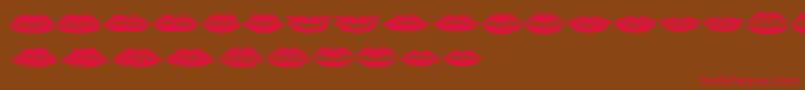 フォントLippen – 赤い文字が茶色の背景にあります。
