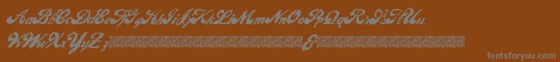 LiquidMagic-fontti – harmaat kirjasimet ruskealla taustalla