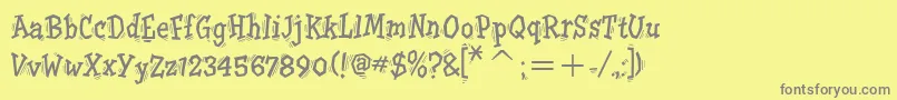 フォントTremoritcTt – 黄色の背景に灰色の文字