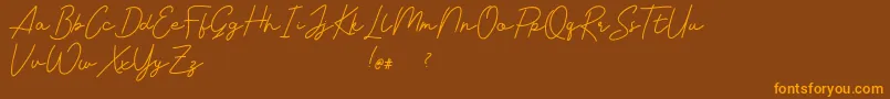 Livvie Signature Font – Orange Fonts on Brown Background