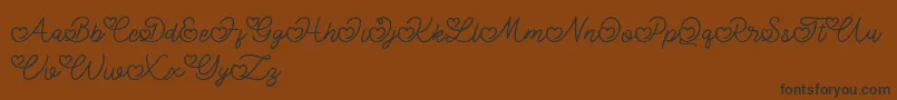 Fonte Lovely Valentine – fontes pretas em um fundo marrom