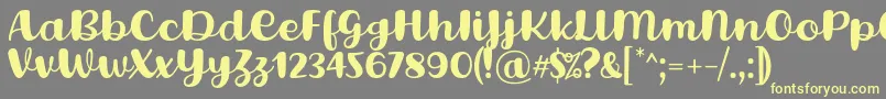 フォントLovina Octover Five Regular Font by Situjuh 7NTypes – 黄色のフォント、灰色の背景