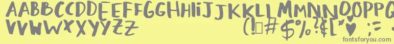 LovingMemories Regular-fontti – harmaat kirjasimet keltaisella taustalla