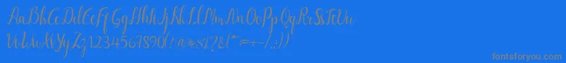 フォントLuciana Script – 青い背景に灰色の文字