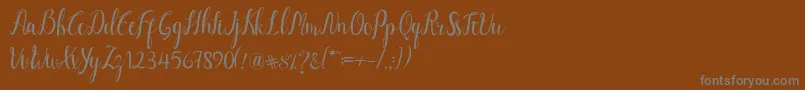Luciana Script-Schriftart – Graue Schriften auf braunem Hintergrund