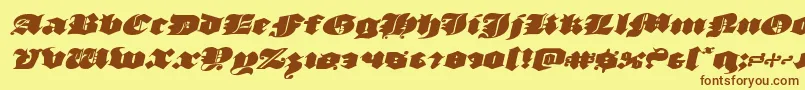 フォントluxcontratenebrasexpandital – 茶色の文字が黄色の背景にあります。